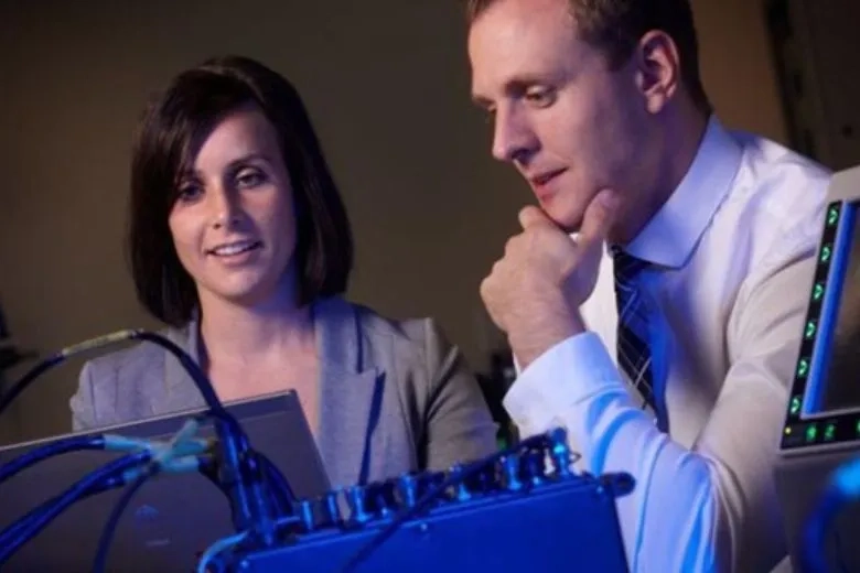 Two people looking at a computer 